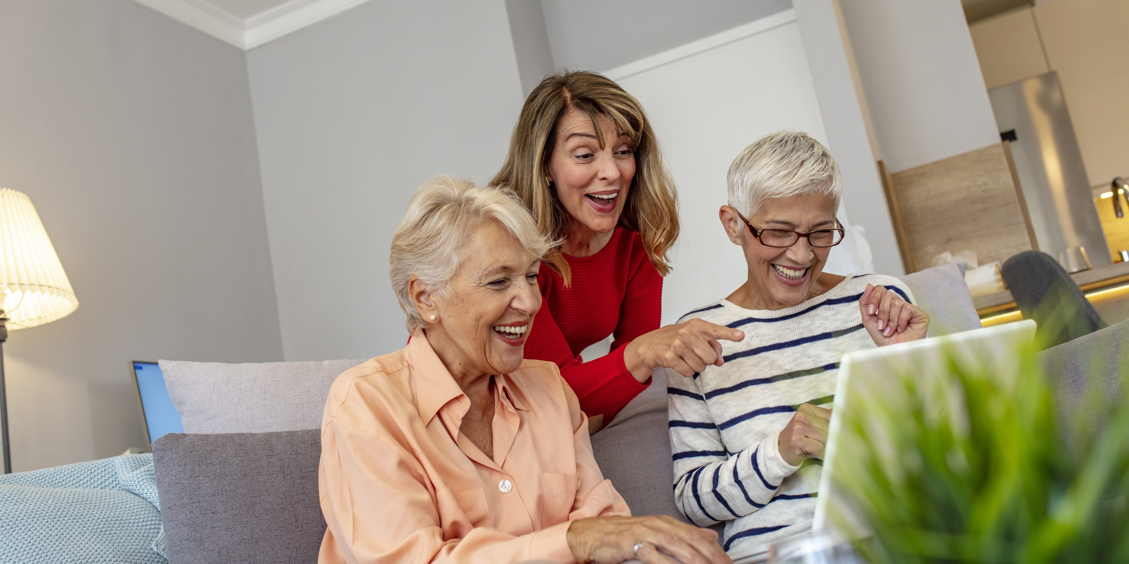 Senior friends using a laptop.